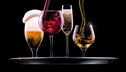 set with different drinks on black background