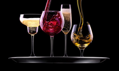 set with different drinks on black background