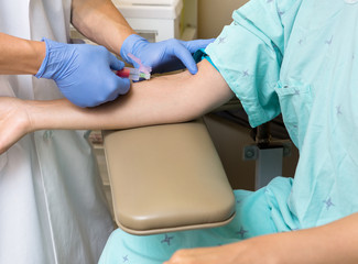 Doctor Drawing Blood From Female Patient's Arm