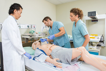 Nurse Adjusting Endotracheal Tube On Dummy Patient