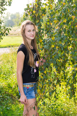 Naklejka na ściany i meble Teen girl near the birch