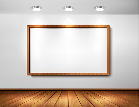 Empty wooden frame on wall with spotlights and wooden floor.