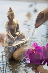 religious incense next to water Buddha