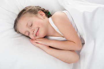 Fototapeta na wymiar cheerful girl sleep in white bed