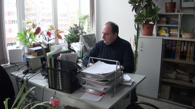 The man in the office at the computer