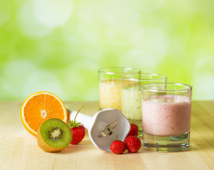 Fruit smoothie on wooden table on narural background