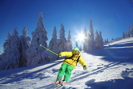 Skier against blue sky in high mountains