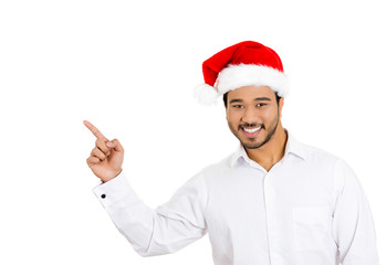 Fototapeta na wymiar Happy christmas man pointing at copy space