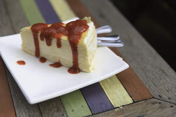 Crepe cake with strawberry sauce