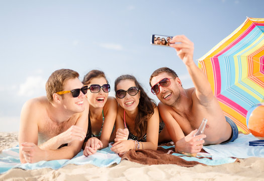 group of people taking picture with smartphone