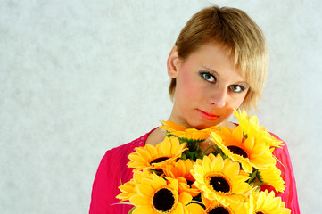 Portrait of a woman with a bouquet of yellow flowers - obrazy, fototapety, plakaty