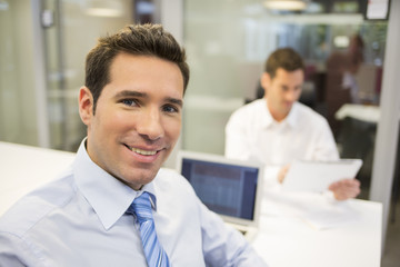 Portrait of smiling businessman working in office