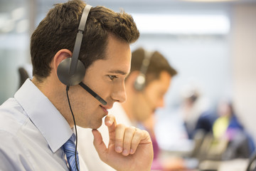 Call center team in the office on the phone with headset
