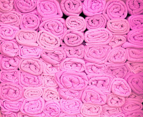 Pink Beach towels rolled up and stacked on each other