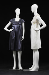 full length two elegant sundress on a mannequin on a black
