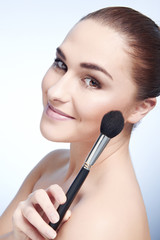 Beauty Girl with Makeup Brushes. Natural Make-up for Brunette Wo