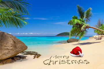 Merry Christmas with santa hat on the tropical beach