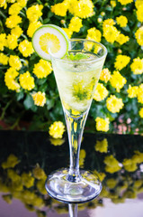 yellow cocktail with a slice of lime