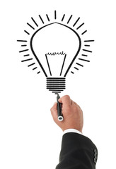 Businessman drawing a lightbulb with a permanent marker