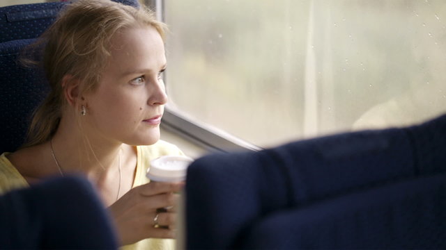 Pensive married woman traveling by train