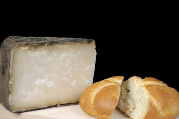 Piece of cheese and bread on a black background