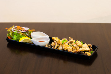 Fried octopus tentacles with sauces