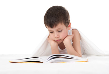 boy read a book in bed