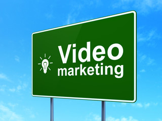 Finance concept: Video Marketing and Light Bulb on road sign