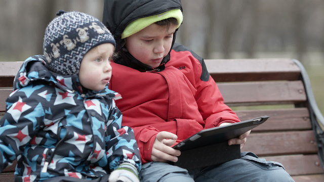 Brothers with tablet computer