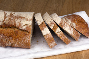 loaf of bread cut into slices on a napkin