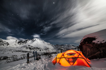 Tent among winter mountains. Stock image