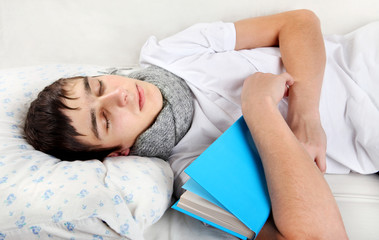 Fototapeta na wymiar Young Man sleeps with a Book