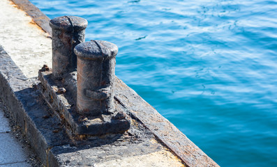 Old and rusty ships mooring bollard.