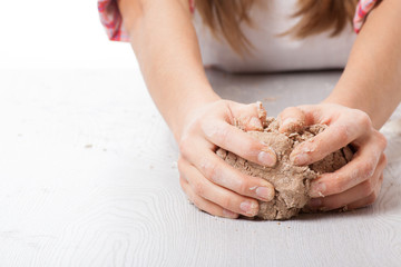 hands knead rye dough