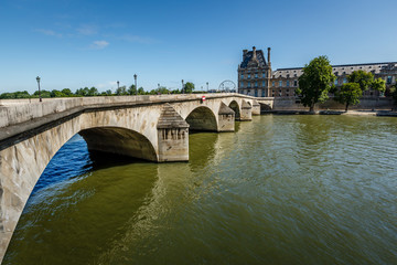 Naklejka premium View of Louvre Palace and Pont Royal in Paris, France