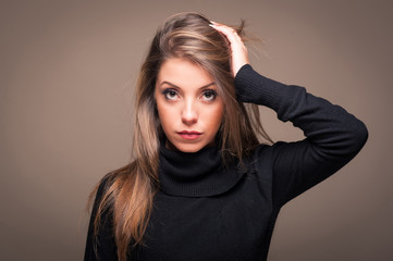 Intimate portrait of woman on dark background.