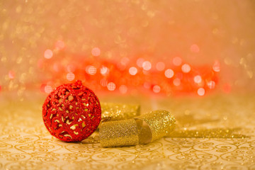 Christmas decorations on golden background with red lights blur