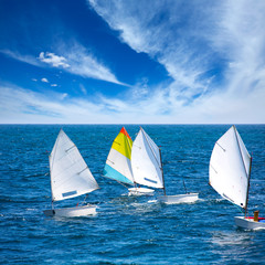 Sailboats Optimist learning to sail in Mediterranean at Denia