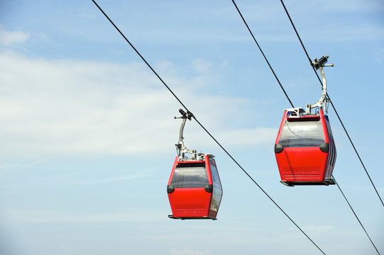 Red Overhead Cable Cars Blue Sky