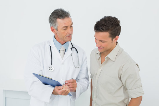 Doctor discussing reports with patient at office