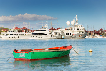 Fishing boat with luxurious yachts background, Eden Island, Mah