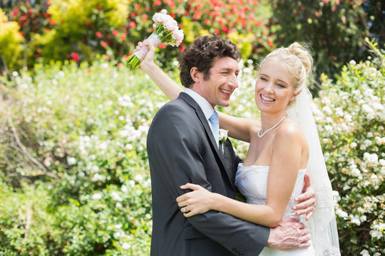Romantic happy newlyweds embracing each other