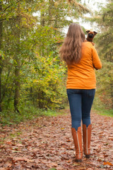 Walking back in the forest with a dog