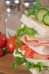 Fresh club sandwich in rustic kitchen setting