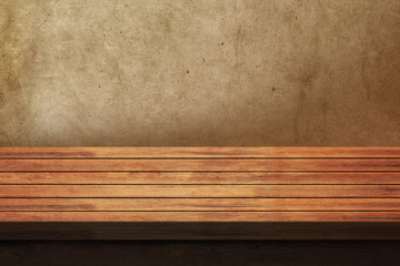 Empty wooden table over grunge background