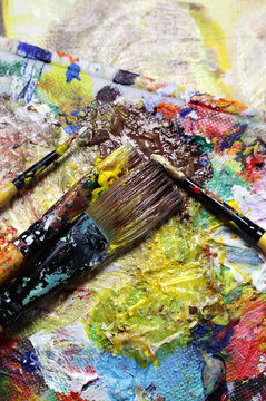 Beautiful vivid art palette and mix of paintbrushes