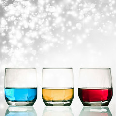 Glasses of shots on abstract background