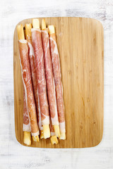 Italian breadsticks with ham. Tasty appetizer, mediterranean cui