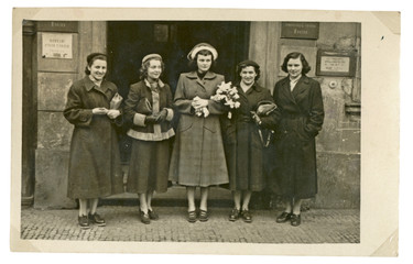 CIRCA 1949 - young women before old building