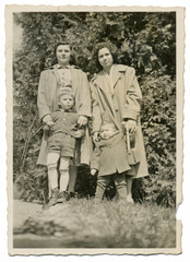 Fototapeta na wymiar Two young mothers with their children - circa 1950